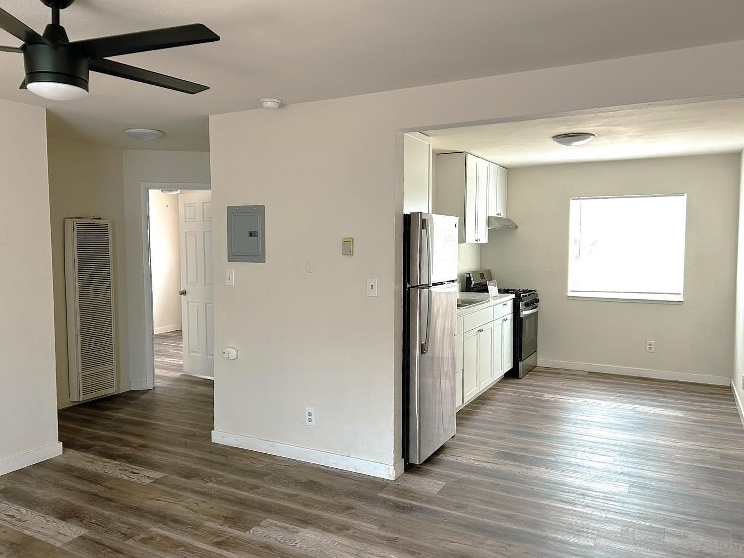Open living area looking into a renovated kitchen
