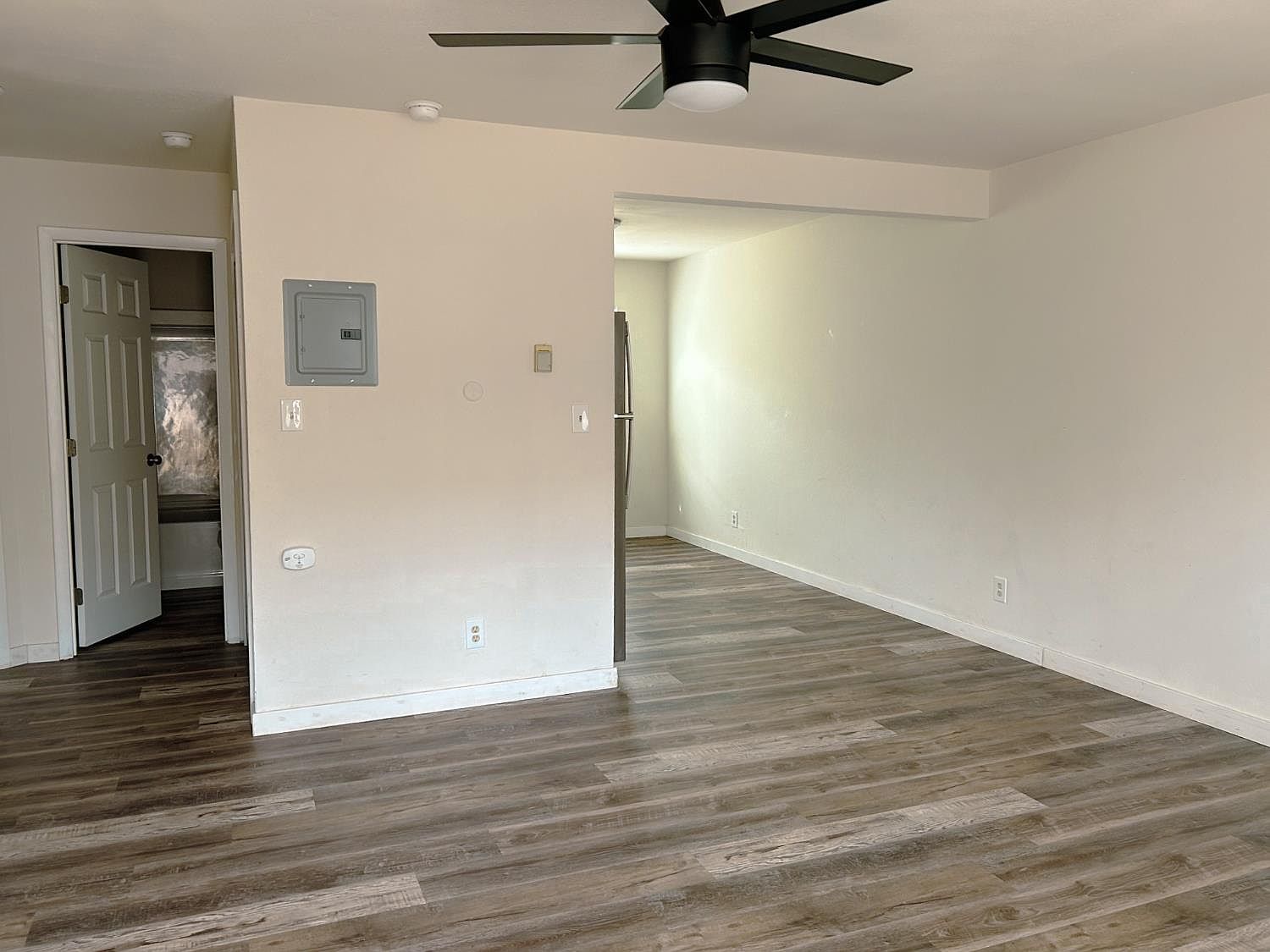 Living room with new vinyl plank flooring and ceiling fan