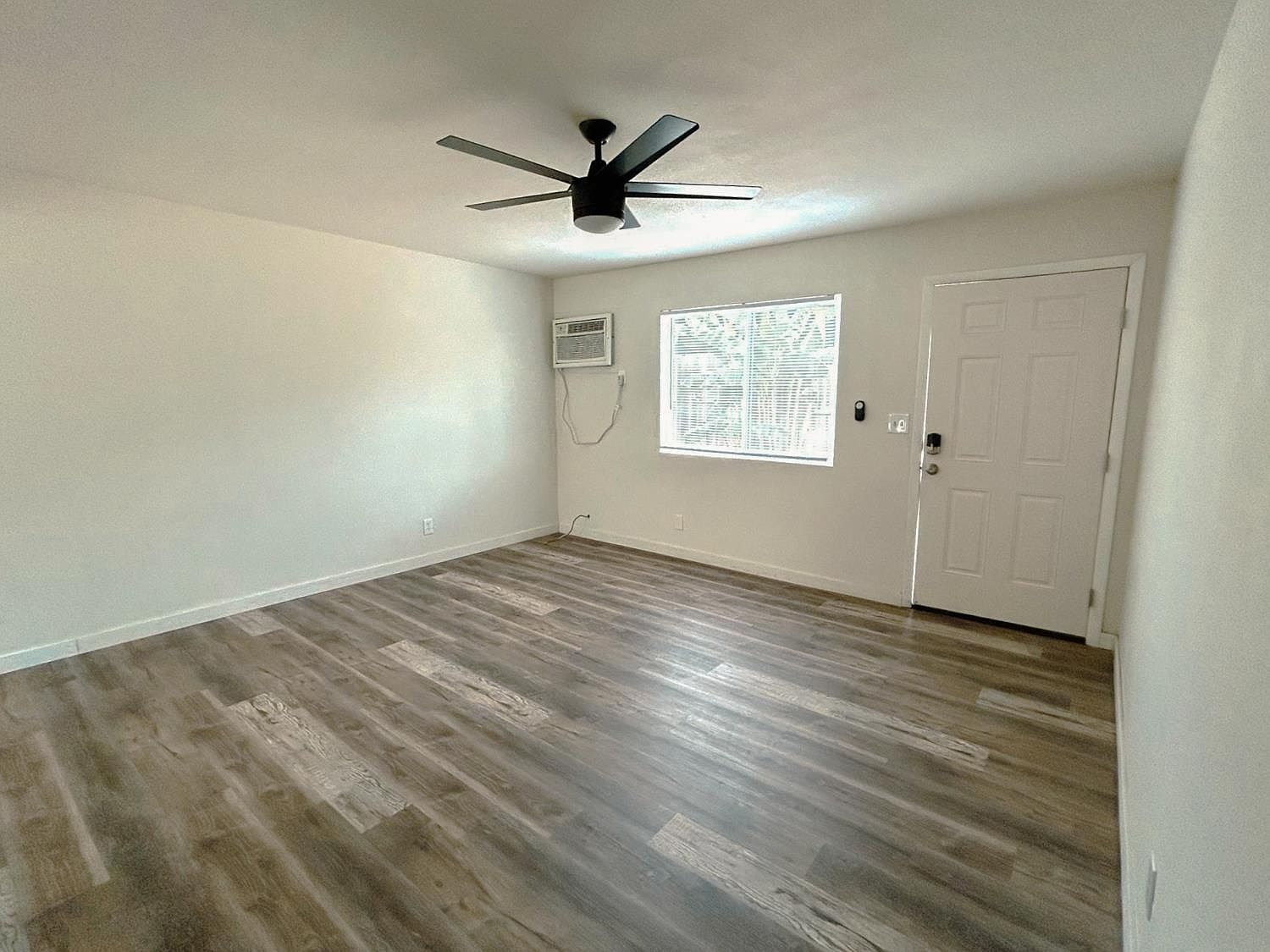 Living room with new flooring and ceiling fan