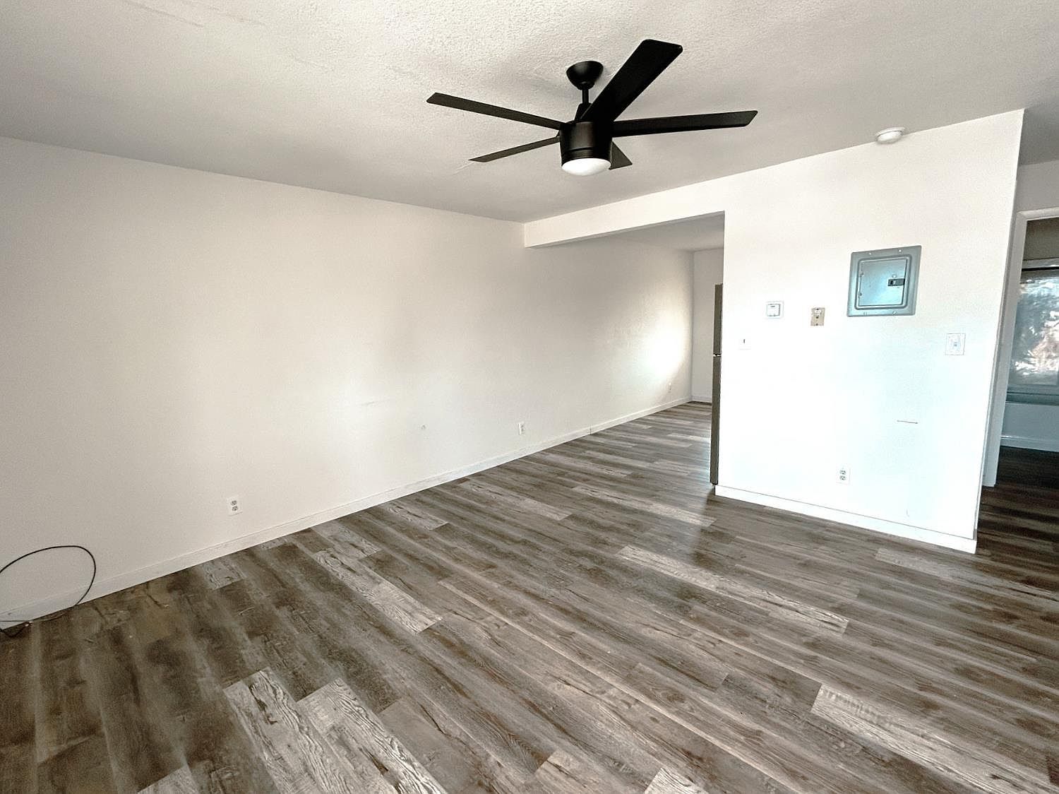 Open living area with ceiling fan