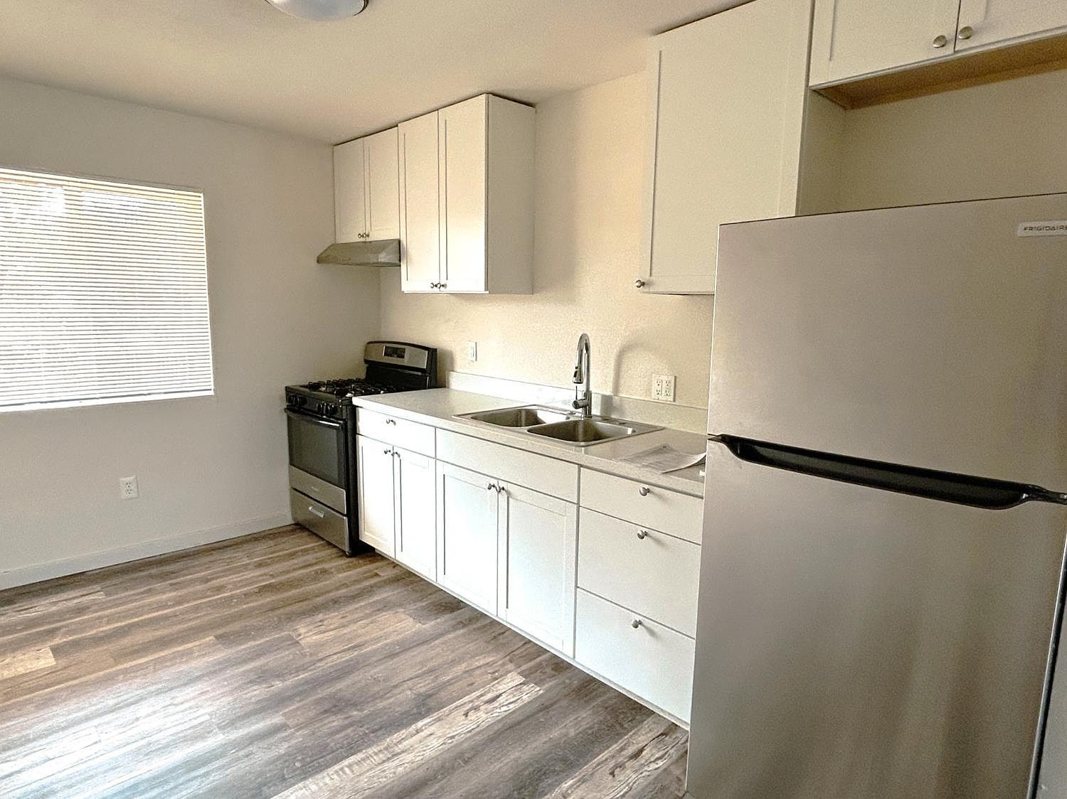 Kitchen with stainless steel appliances and white cabinetry