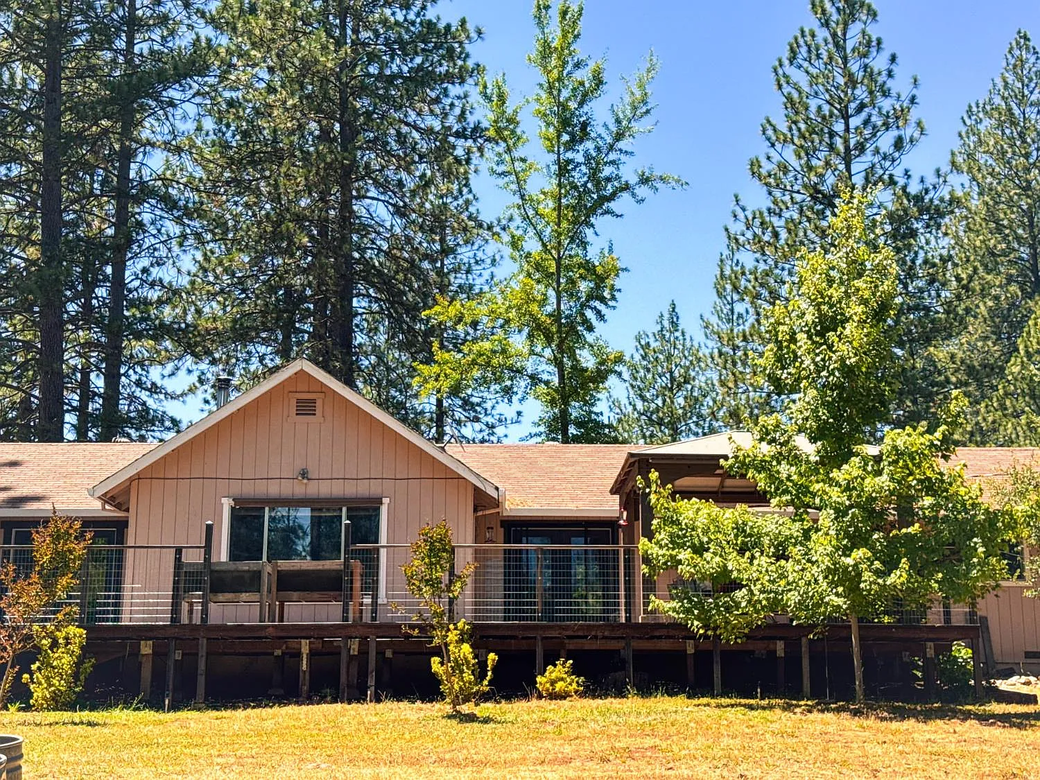 Side elevation of the home showing the full-length deck and railing